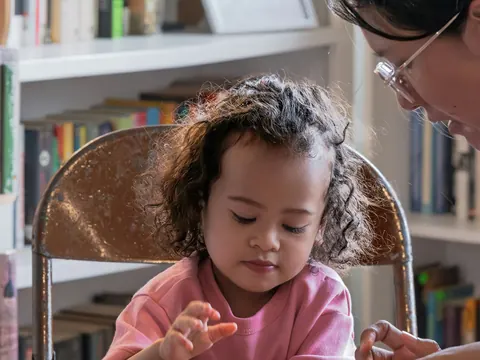 Teacher and child reading together
